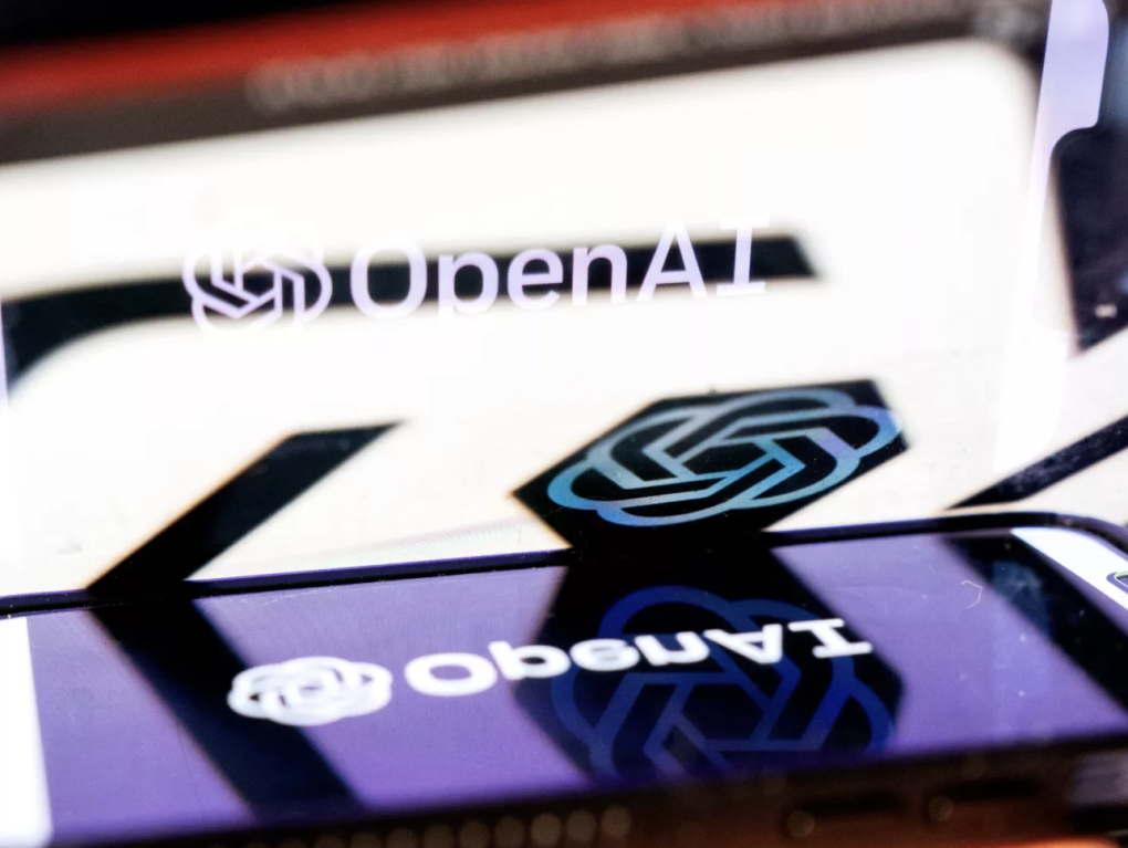 A smartphone screen reflects the image and logo of OpenAI.